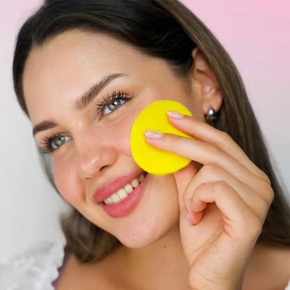 Woman using a yellow turmeric and kojic acid pad on her cheek for skin brightening-DILMIR